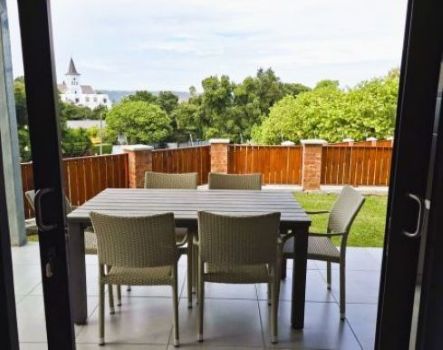 backyard with green grass and wood fence